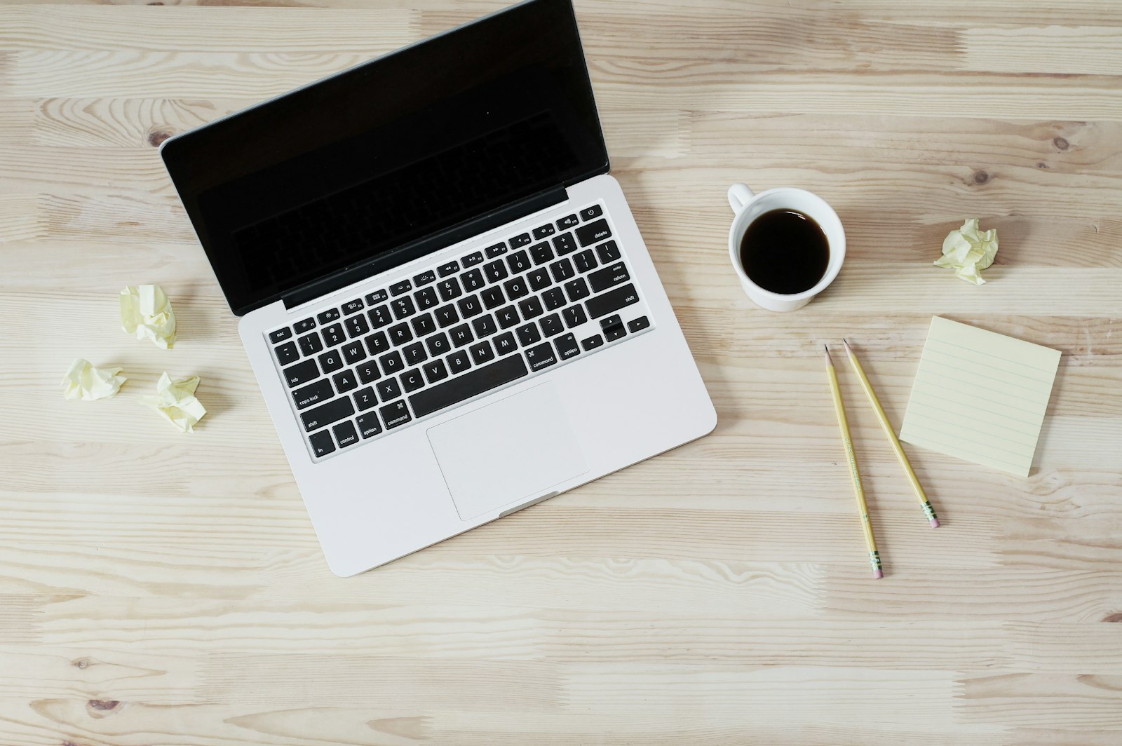 Post-doctoral researcher at desk with manuscript